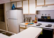 Thumbnail 6 of 11 - Kitchen with white cabinets and appliances at ARBORS OF KILLEEN, Texas 76542
