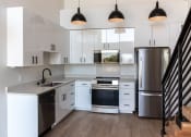 Thumbnail 9 of 24 - a kitchen with white cabinets and stainless steel appliances at Luella, Sacramento, CA, 95811