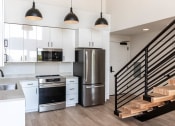 Thumbnail 10 of 24 - a kitchen with white cabinets and a stainless steel refrigerator at Luella, Sacramento, California