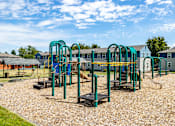 Thumbnail 3 of 20 - A playground with a slide, swings, and a seesaw.at Lake Washington Apartments, Seattle, 98118