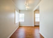 Thumbnail 12 of 20 - A room with wooden floors and white walls.at Lake Washington Apartments, Seattle, WA 98118