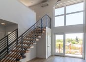 Thumbnail 11 of 24 - a living room with a staircase and a door to a balcony at Luella, Sacramento