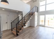 Thumbnail 13 of 24 - a staircase in a home with wood floors and white walls at Luella, Sacramento, CA