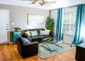 Thumbnail 7 of 11 - Living room with window and wood floors at ARBORS OF KILLEEN, KILLEEN, TX