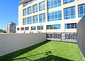 Thumbnail 17 of 20 - A modern building with a grassy area in front at LOFT 205 Apartments, Nevada, 89501