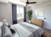 Thumbnail 16 of 24 - a bedroom with a bed and a ceiling fan at Luella, California