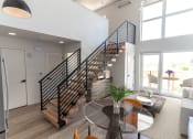 Thumbnail 21 of 24 - a living room with a staircase and a glass table at Luella, California