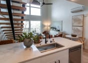 Thumbnail 6 of 24 - a kitchen with a sink and a counter top in a living room at Luella, Sacramento