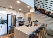 Thumbnail 5 of 24 - a kitchen with a white counter top and a stainless steel refrigerator  at Luella, Sacramento, California