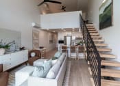 Thumbnail 4 of 24 - a living room with a couch and a table and stairs at Luella, Sacramento, CA, 95811