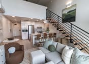 Thumbnail 23 of 24 - a living room with a couch and a kitchen and stairs at Luella, Sacramento, California