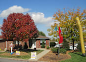Thumbnail 15 of 28 - A house with a yard and a sign in front of it.