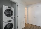 Thumbnail 24 of 33 - a washer and dryer in a room with a door to a closet