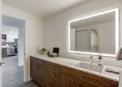 Thumbnail 17 of 33 - a bathroom with a large mirror and a sink