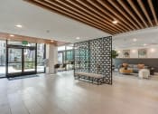 Thumbnail 23 of 33 - a lobby with a lobby area with a seating area and glass doors
