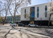 Thumbnail 14 of 33 - the exterior of a building with cars parked in front of it