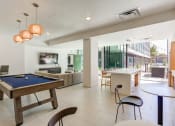 Thumbnail 25 of 33 - a game room with a pool table and a bar