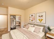 Thumbnail 6 of 29 - A bedroom with a bed, nightstand, and two framed artworks on the wall. at Fairview Village Apartments, Oregon