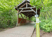 Thumbnail 13 of 29 - A wooden bridge at Fairview Village Apartments, Fairview, 97024