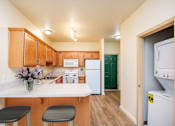 Thumbnail 14 of 34 - A kitchen with wooden cabinets and a white counter top. at Fairview Village Homes, Fairview, OR