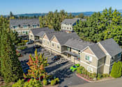 Thumbnail 30 of 34 - A large building surrounded by trees and a parking lot. at Fairview Village Homes, Fairview, OR