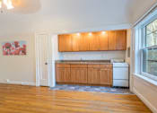 Thumbnail 6 of 36 - A kitchen with wooden cabinets and a white dishwasher.at Palladian Apartments, Oregon, 97201?