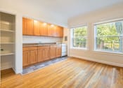 Thumbnail 9 of 36 - A kitchen with wooden floors and cabinets.at Palladian Apartments, Oregon, 97201?