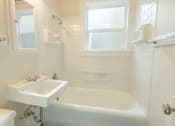 Thumbnail 26 of 36 - A white bathroom with a tub, sink, and toilet.at Palladian Apartments, Oregon ? 