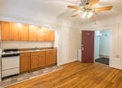 Thumbnail 7 of 36 - A kitchen with wooden floors and a ceiling fan.at Palladian Apartments, Portland, 97201 ? 