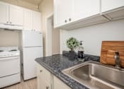 Thumbnail 22 of 36 - A kitchen with a stove, dishwasher, and sink.at Palladian Apartments, Portland, OR ? 