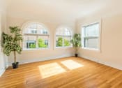 Thumbnail 3 of 36 - A room with wooden floors and two potted plants.at Palladian Apartments, Portland, OR 97201 ? 