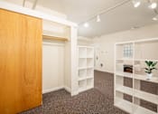 Thumbnail 19 of 36 - A room with a wooden door and shelves.at Palladian Apartments, Portland, OR 97201 ? 