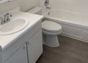 Thumbnail 21 of 24 - A white toilet with a white sink and a white bathtub with a glass door.at OTAVON APARTMENTS, Novato