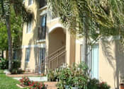 Thumbnail 9 of 15 - Exterior building view with trees at Bernwood Trace Apartments, Fort Myers, FL, 33966
