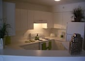 Thumbnail 13 of 15 - Kitchen with white cabinets at Bernwood Trace Apartments, Florida