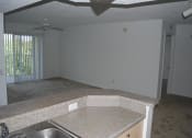 Thumbnail 14 of 20 - Portofino Apartments kitchen over looking living area at Portofino, Palm Springs, FL