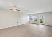 Thumbnail 15 of 39 - A room with a ceiling fan and sliding glass doors.