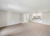 Thumbnail 19 of 39 - A spacious room with light wood flooring and white walls.