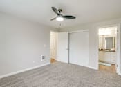 Thumbnail 38 of 39 - A room with a ceiling fan and carpeted floor.