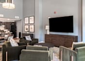 Thumbnail 19 of 20 - A living room with a black screen on the wall.