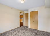 Thumbnail 14 of 26 - A room with a carpeted floor and a doorway leading to another room at Vintage at Burien,Burien,98168