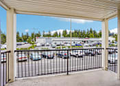 Thumbnail 16 of 26 - A parking lot viewed from a covered walkway at Vintage at Burien, Washington,98168.