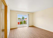 Thumbnail 9 of 26 - A room with a sliding glass door leading to a balcony at Vintage at Burien,Burien,WA
