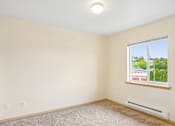 Thumbnail 12 of 26 - A room with a window and a carpeted floor at Vintage at Burien, Burien