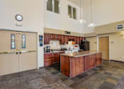 Thumbnail 25 of 26 - A kitchen with a brown counter and a clock on the wall at Vintage at Burien,Burien,WA,98168