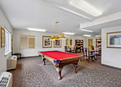 Thumbnail 17 of 26 - A room with a pool table and a bookshelf at Vintage at Burien, Burien, WA