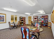 Thumbnail 19 of 26 - A room with a table and chairs and a bookshelf at Vintage at Burien,Burien,WA,98168