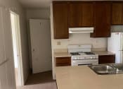 Thumbnail 4 of 5 - an empty kitchen with a stove and a sink