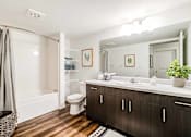 Thumbnail 18 of 18 - A bathroom with a white toilet and a wooden floor at View by Vintage Apartments, Bonney Lake, 98391