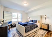 Thumbnail 17 of 18 - A bedroom with a large bed and a window at View by Vintage Apartments, Washington